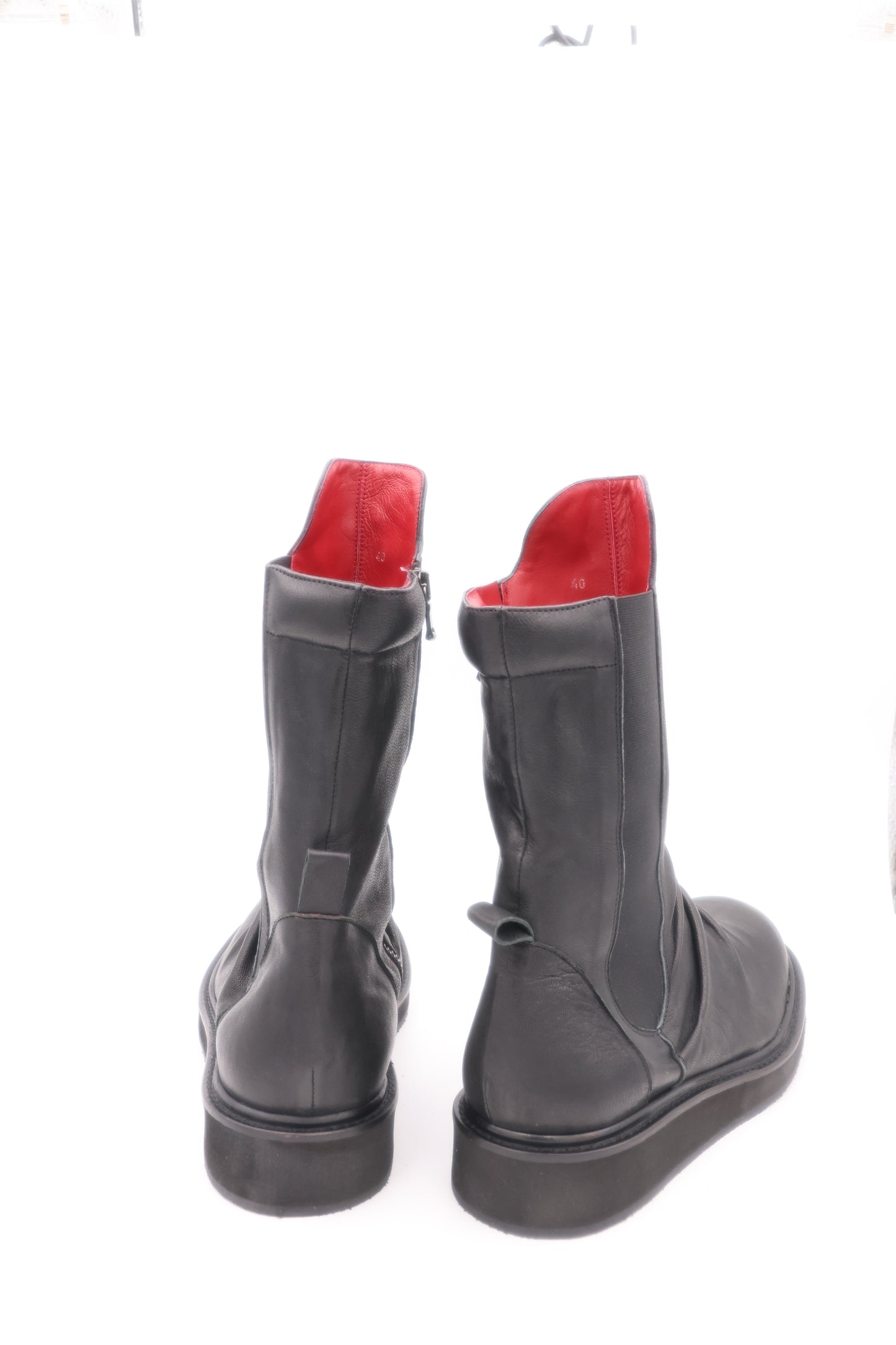 Gray boots with red soles on a white background