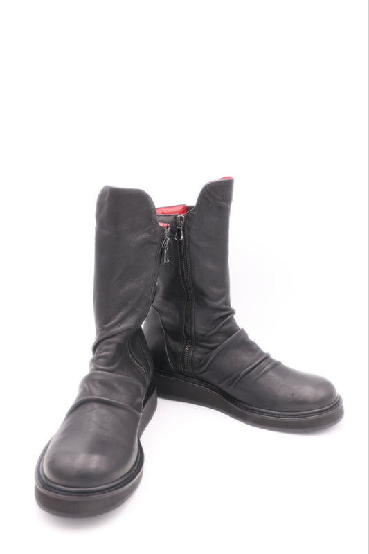 Pair of black leather boots on a white background