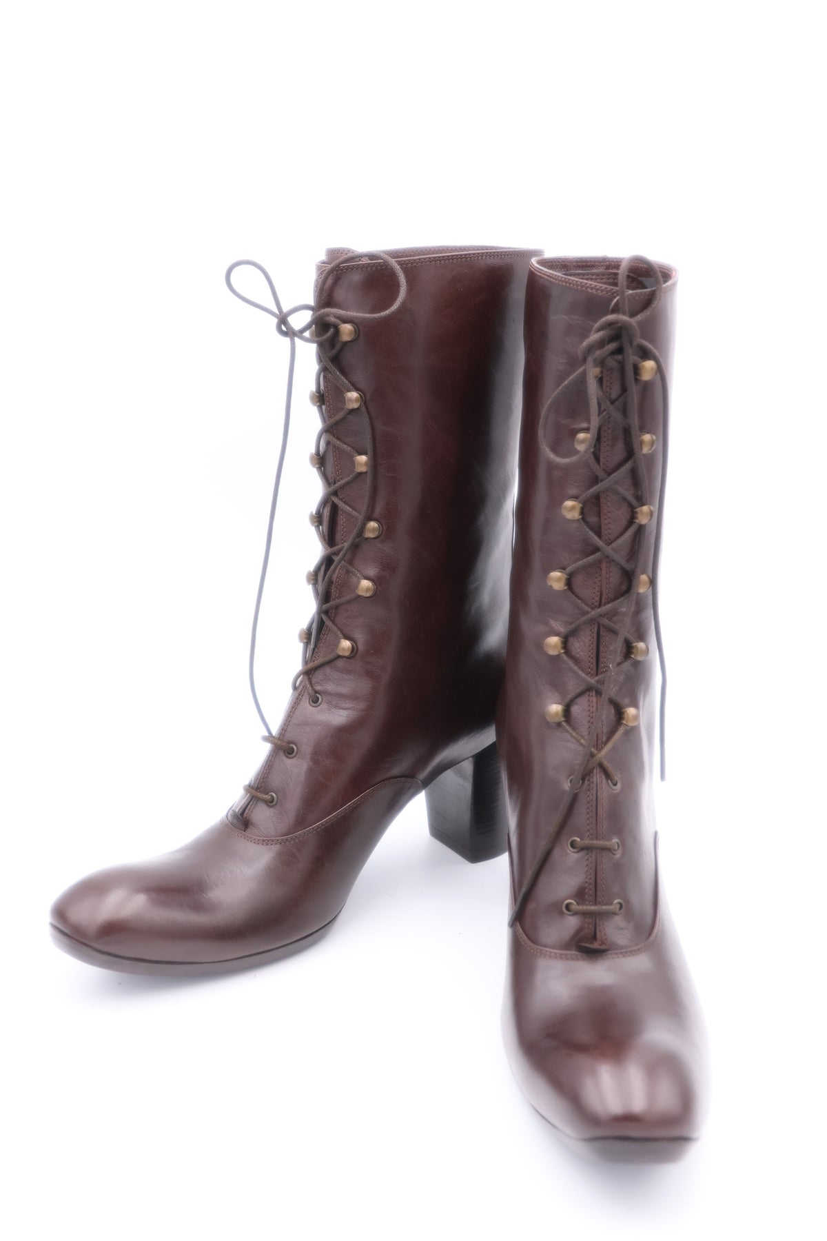Pair of brown knee-high boots with lace-up design on a white background