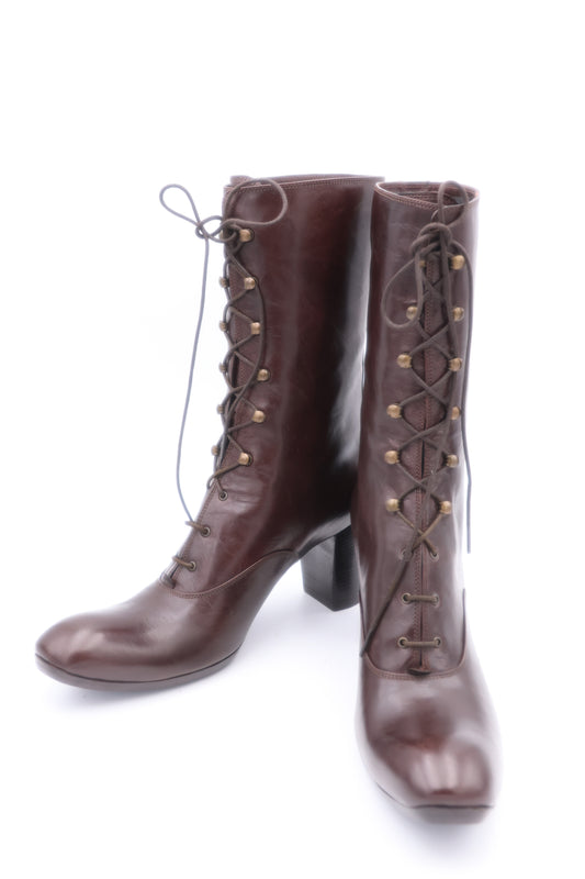 Pair of brown knee-high boots with lace-up design on a white background