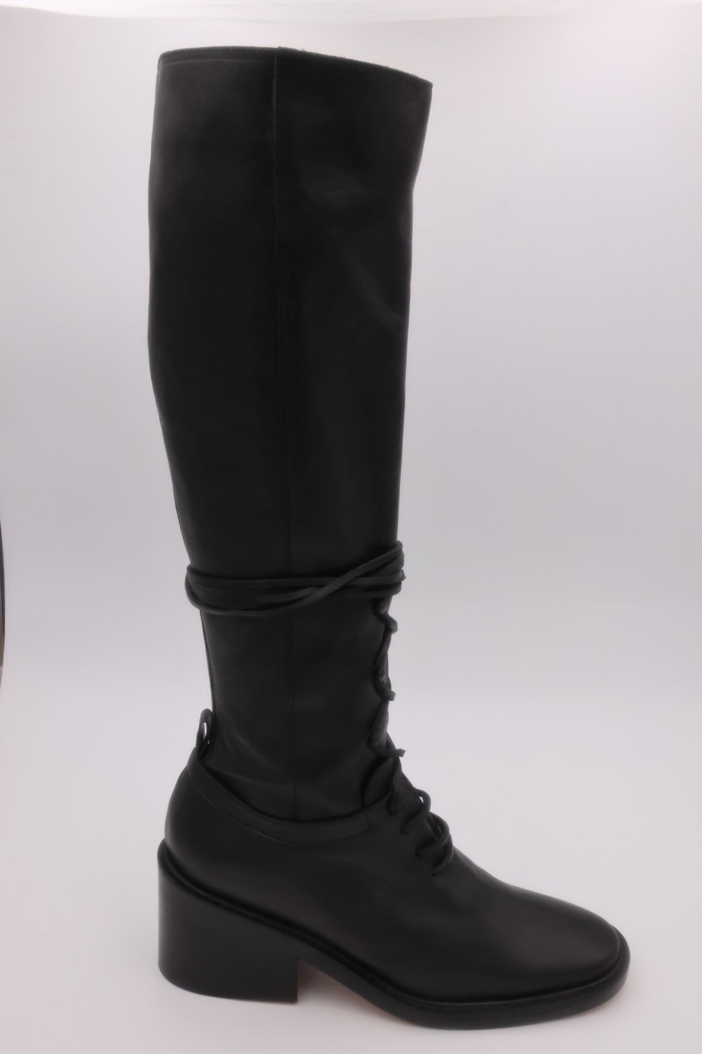 Black knee-high boot on a white background