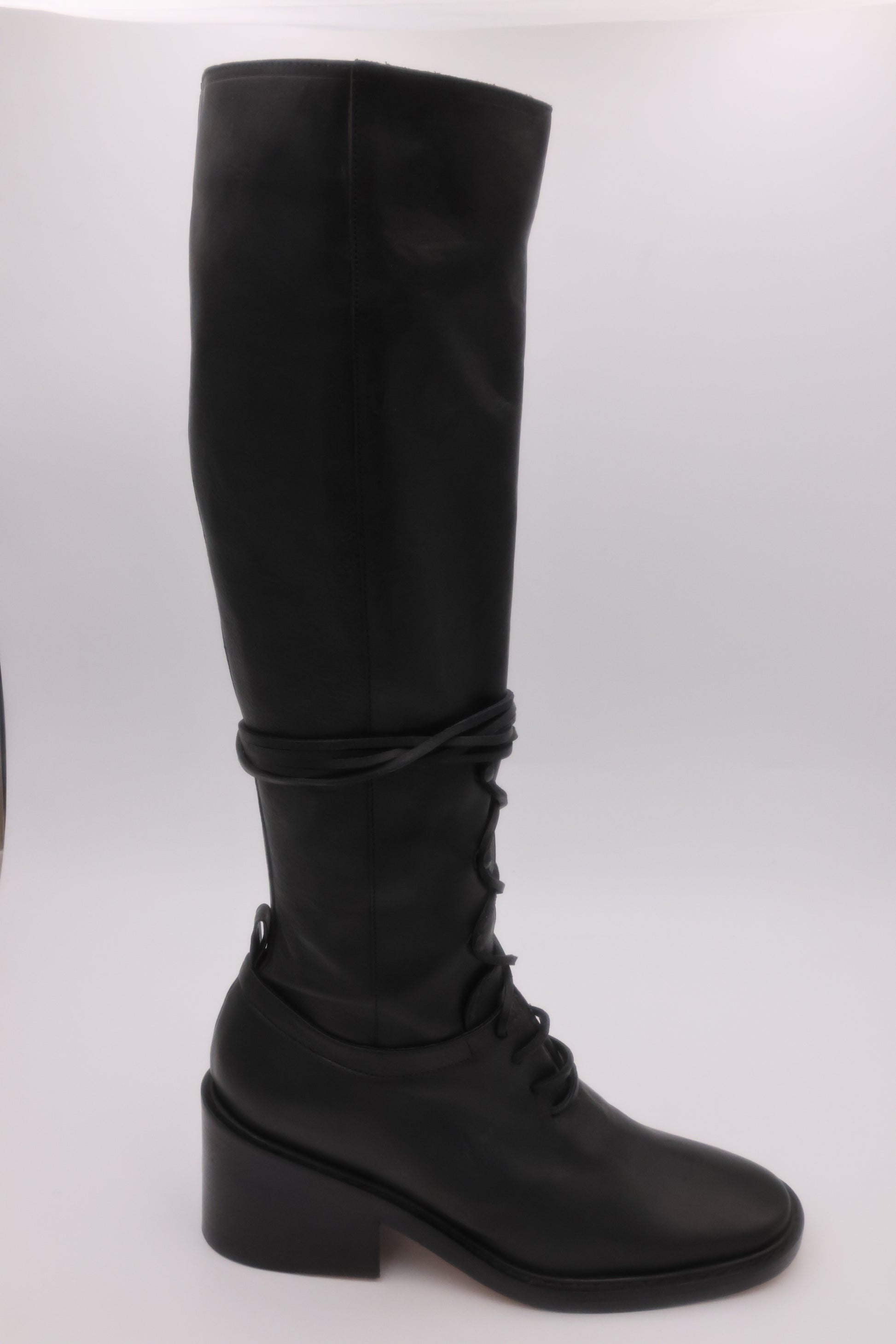 Black knee-high boot on a white background