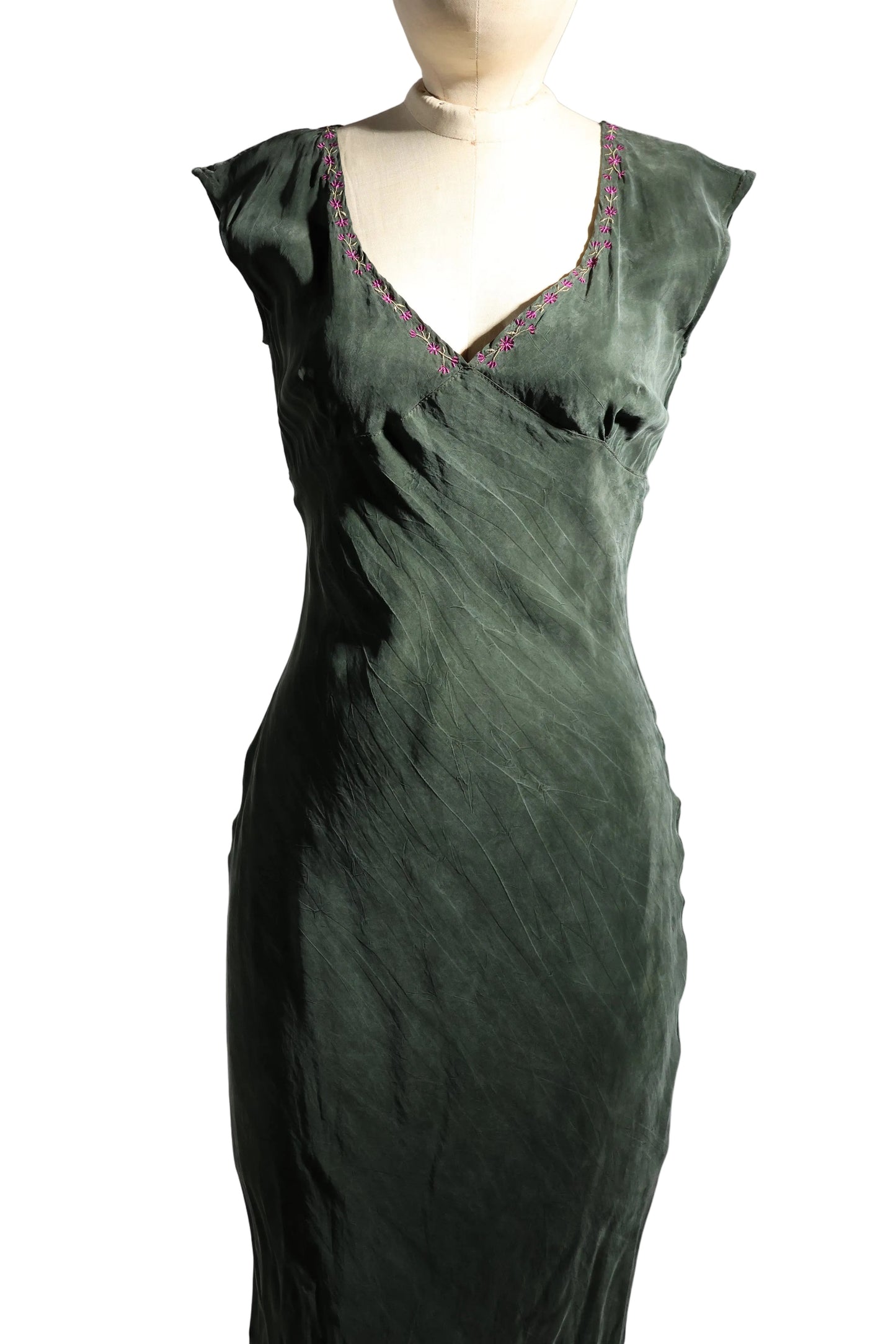 Green satin nightgown on a mannequin against a plain background