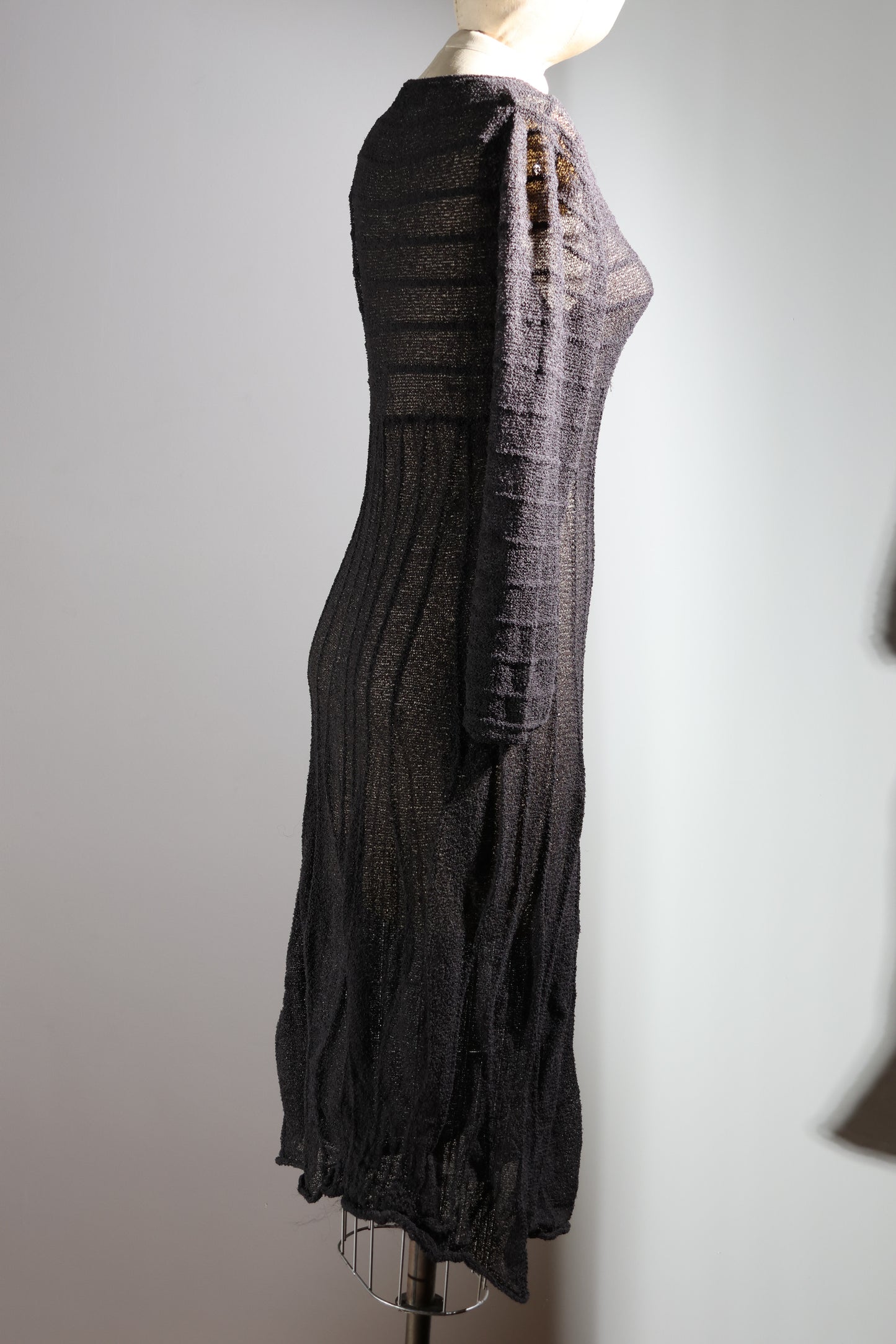 Dark gray dress on a mannequin against a plain background