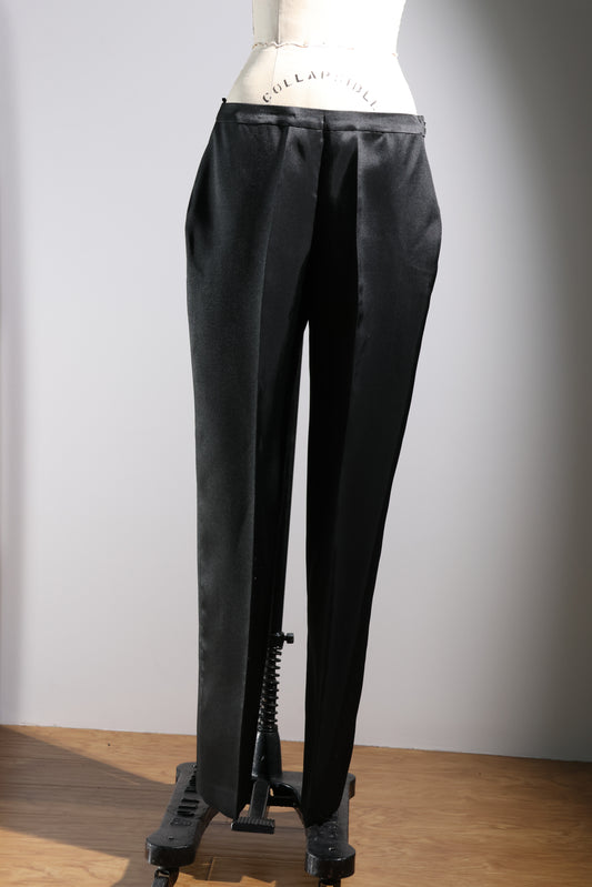 Black silk pants on a mannequin against a plain background