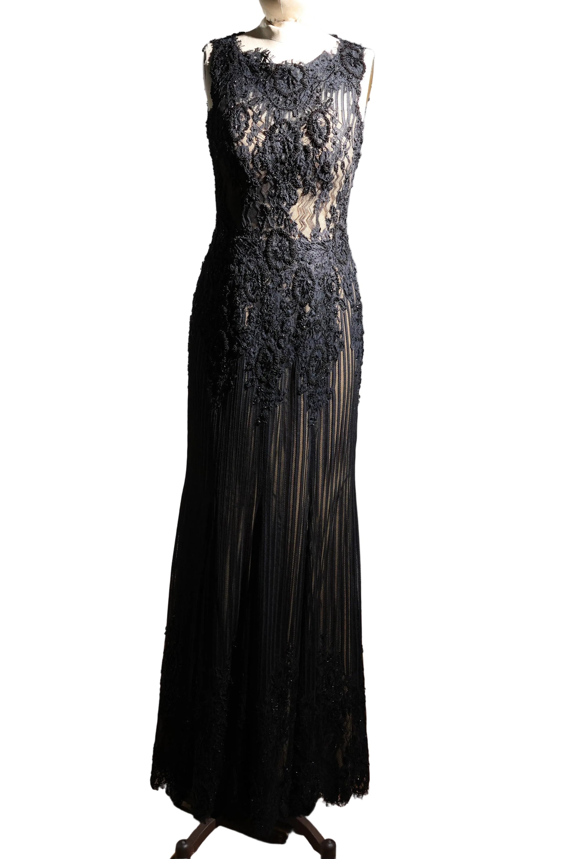 Black lace evening gown on a mannequin against a plain background