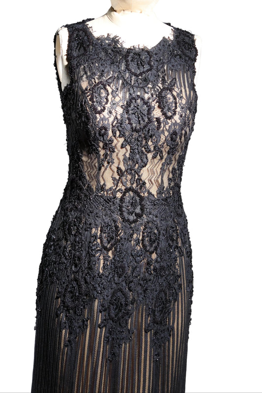 Black lace dress on a mannequin against a gray background