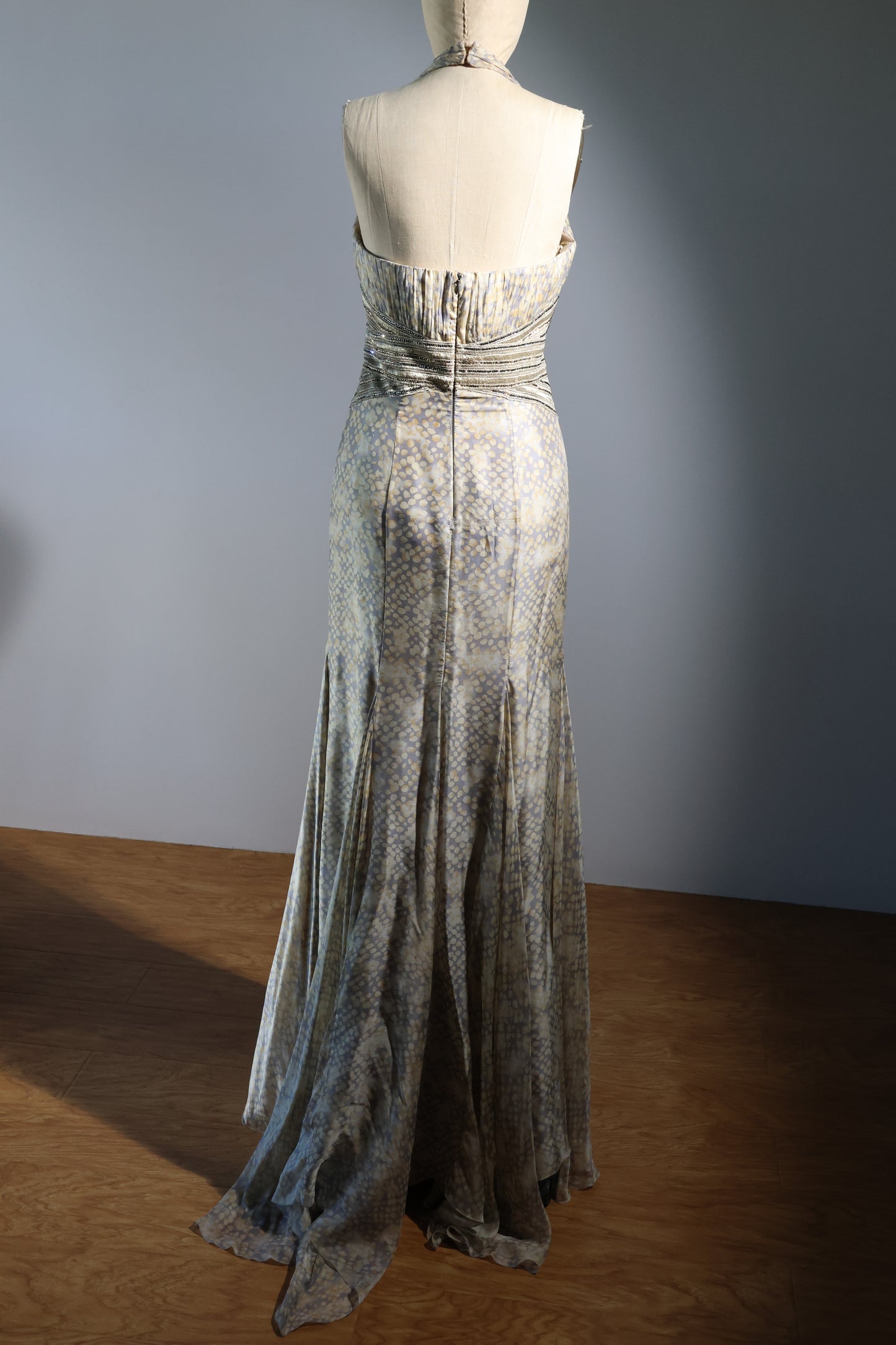 Long, patterned dress on a mannequin against a plain background